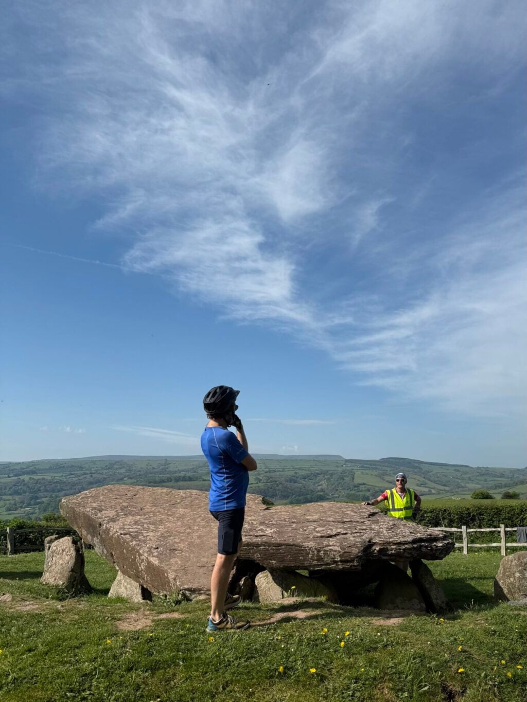 Cyclists visiting Arthur's Stone, an ancient Neolithic monument in Herefordshire, during a White Heron Meander tour.