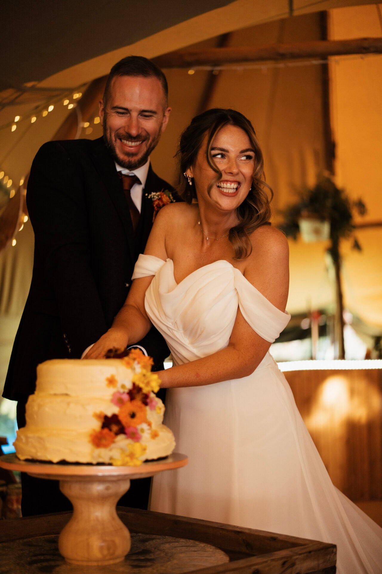 Bride and Groom cutting wedding cake at White Heron Estate Herefordshire
