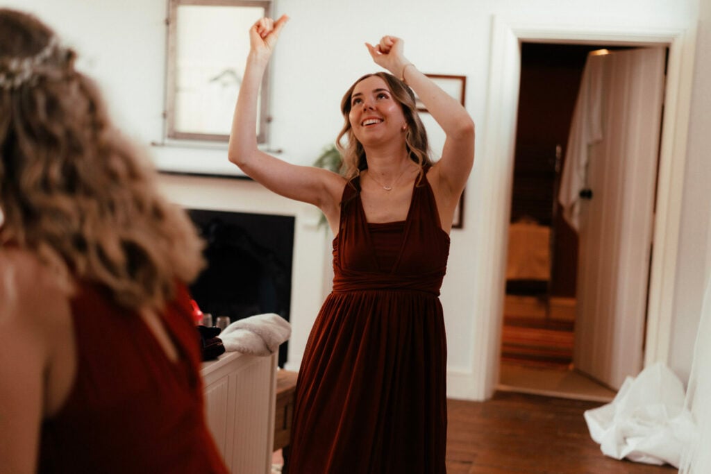 Bridesmaid dancing in the bridal suite at The Colloquy at White Heron Estate wedding venue Herefordshire