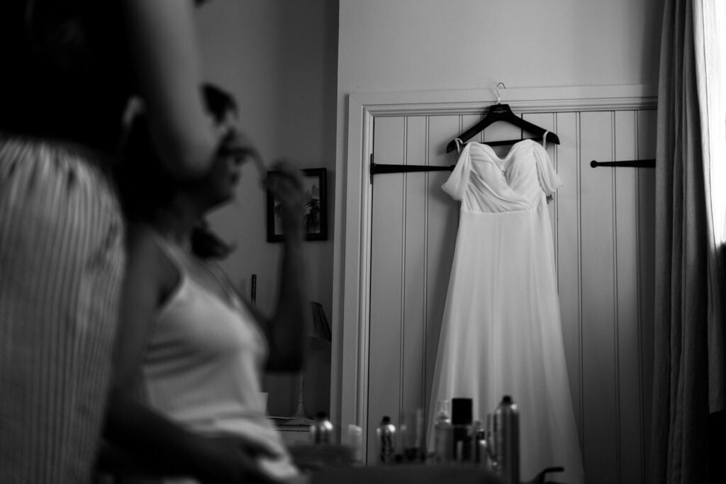 Bride having her hair styled before her wedding at The Colloquy at White Heron Estate wedding venue Herefordshire